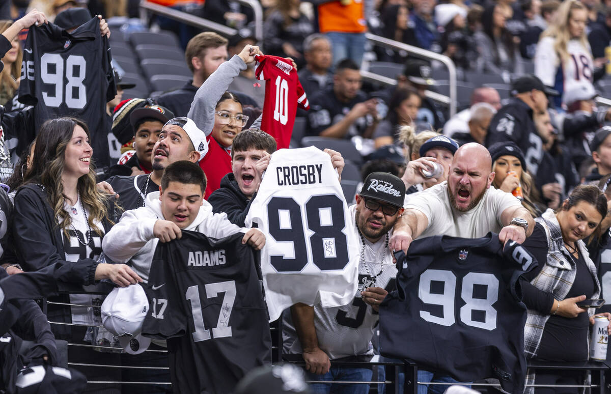 Raiders defensive end Maxx Crosby (98) and wide receiver Davante Adams (17) fans wave their jer ...