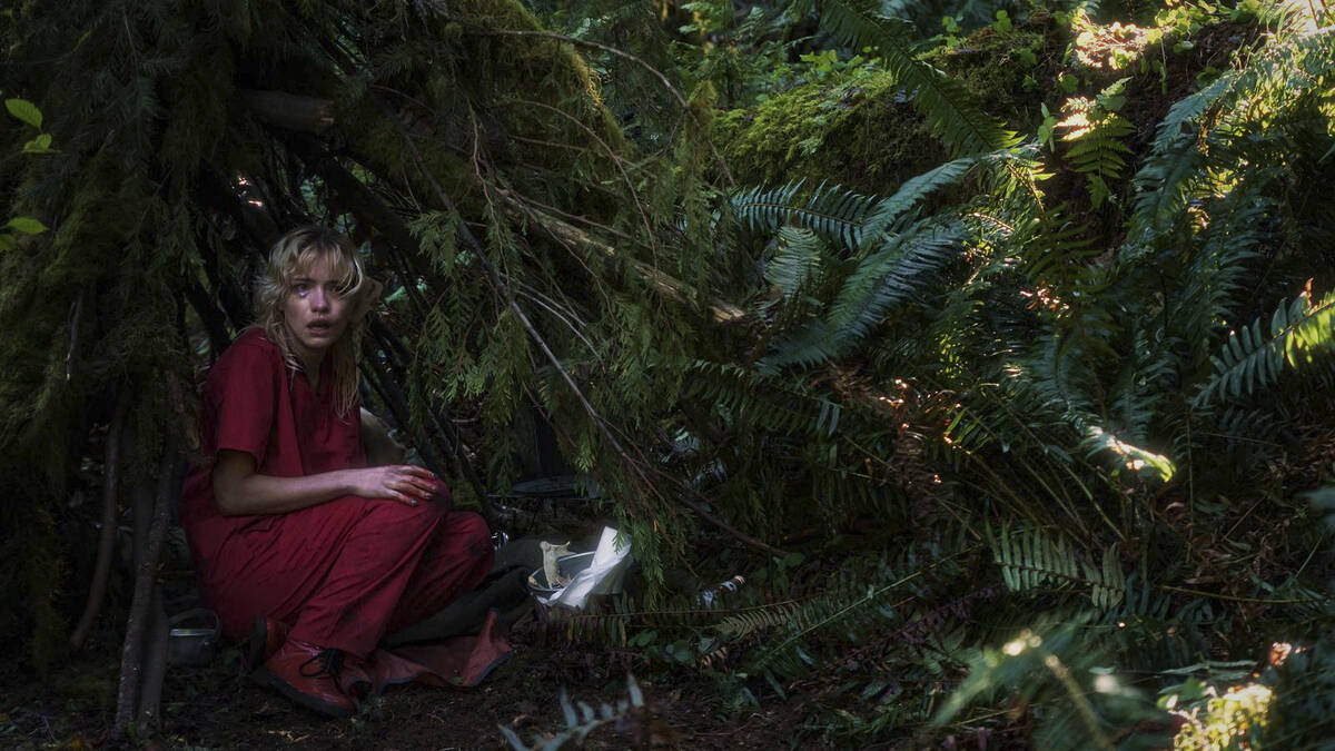 "The Lady" (Willa Fitzgerald) hides in the forest in a scene from JT Mollner's "Strange Darling ...