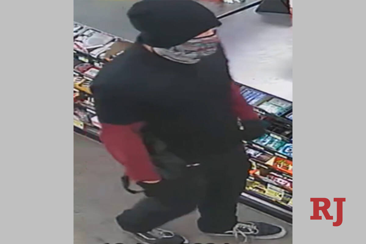 A surveillance photo of a suspect wanted in a string of armed robberies over the past three mon ...