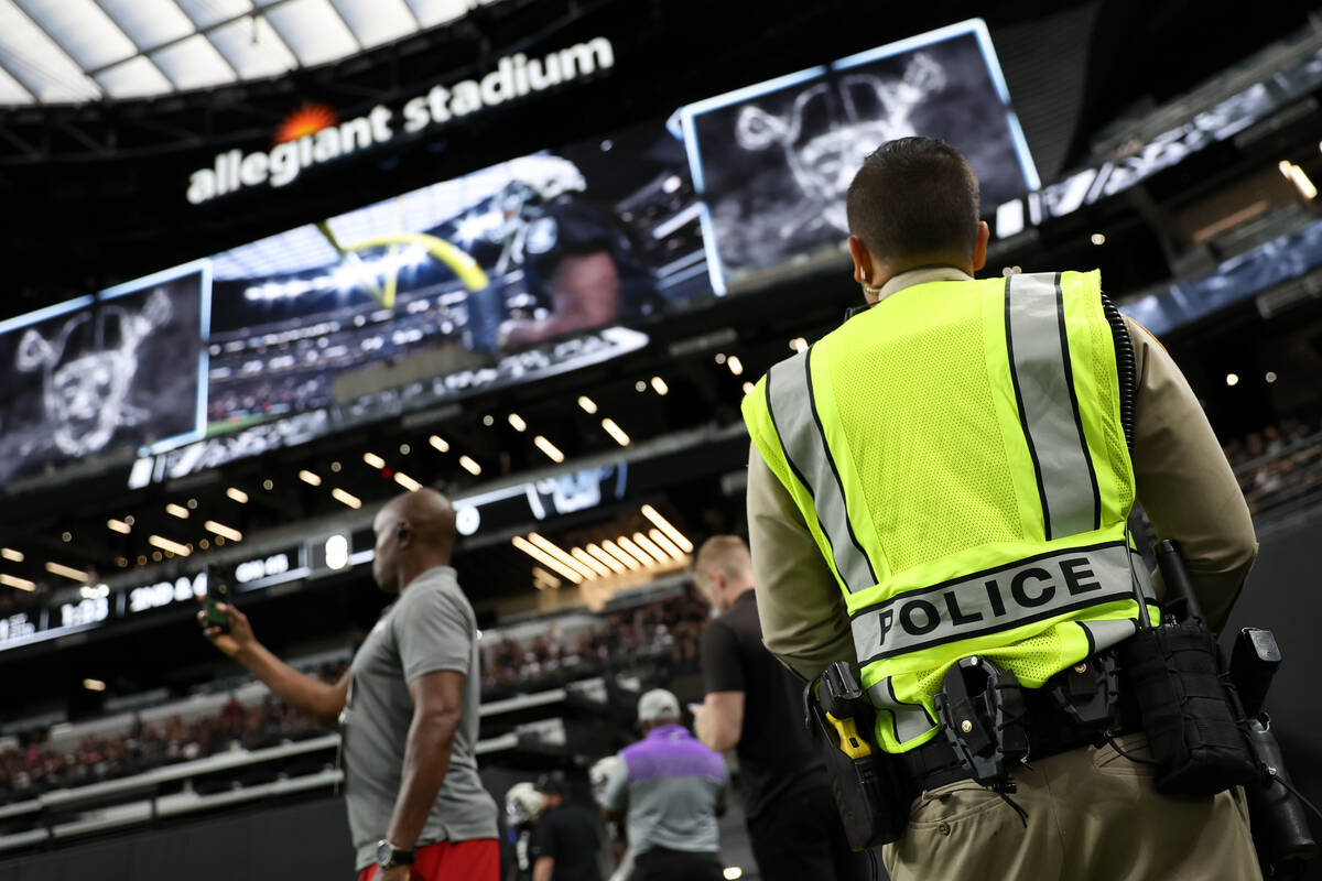 A Metropolitan Police Department officer works during a Raiders NFL football practice at Allegi ...