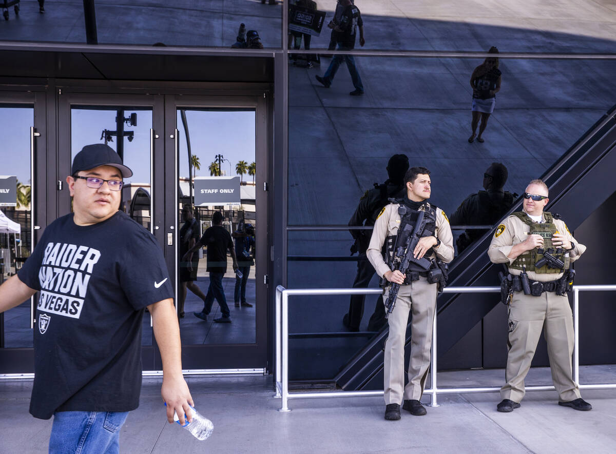 Metro Police stand at an entrance before the Raiders face the Miami Dolphins for their NFL game ...