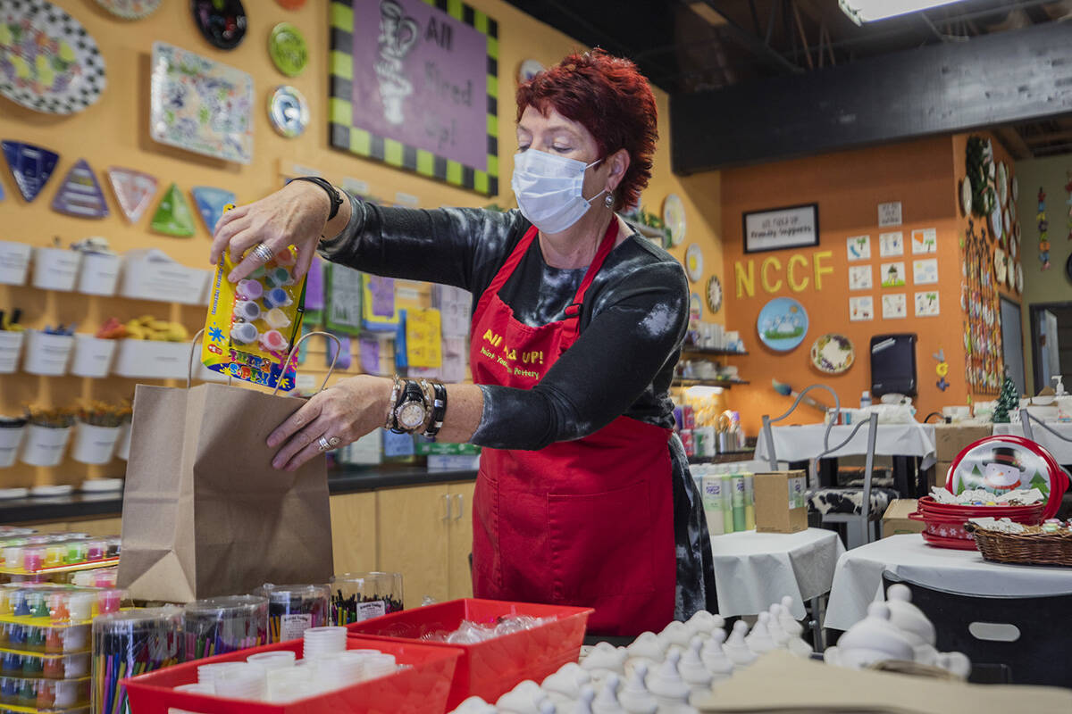 Co-founder of All Fired Up Gail Schomisch packs a holiday pottery to-go kit in the pottery stud ...