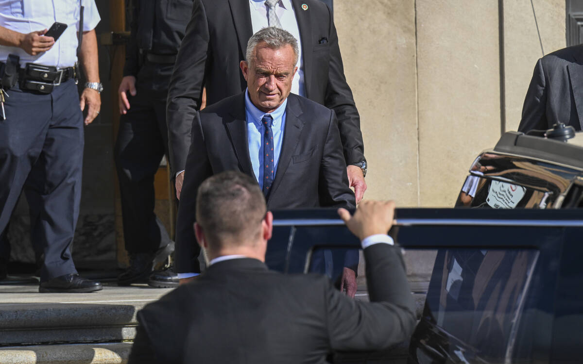 FILE - Independent presidential candidate Robert F. Kennedy Jr., top, leaves after giving testi ...