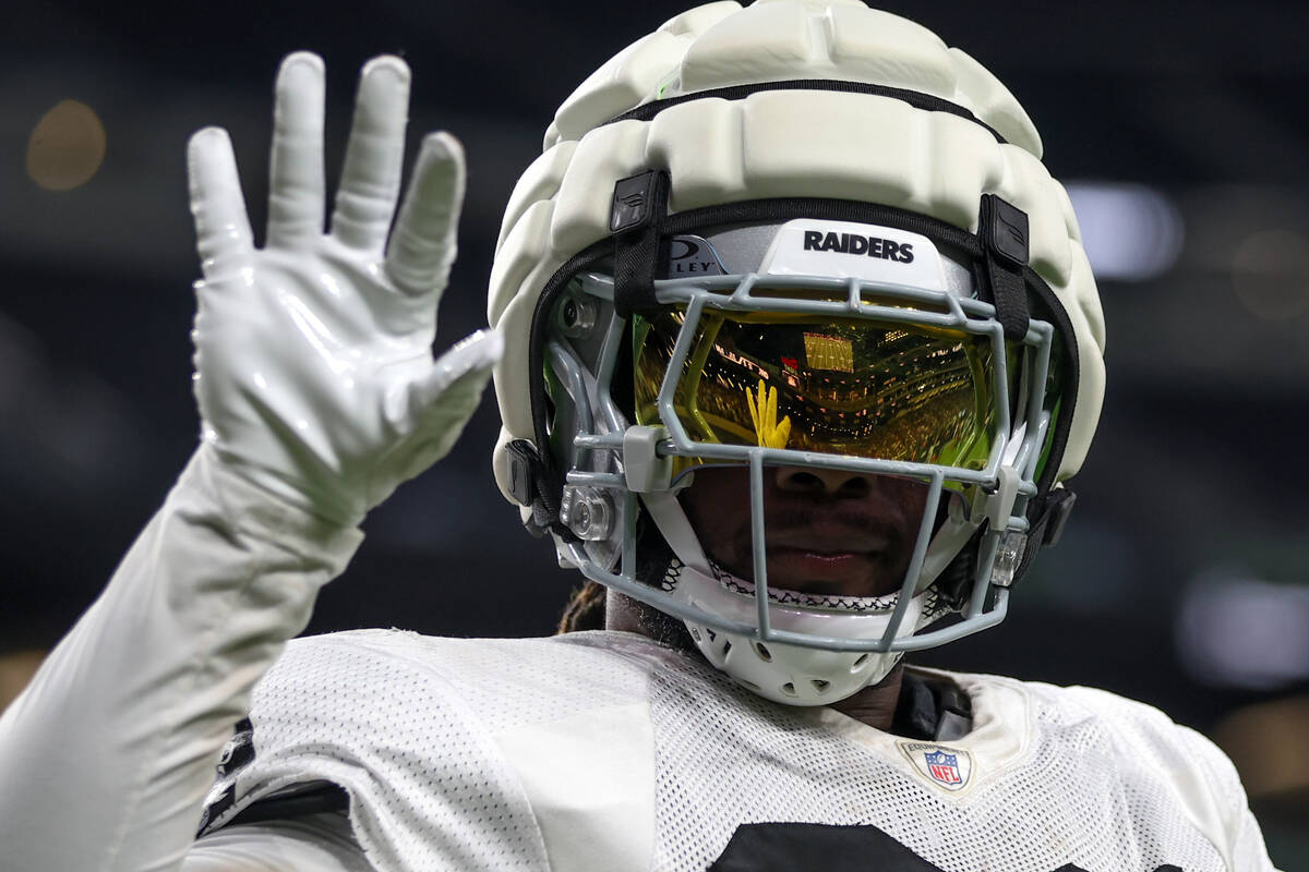 Raiders running back Alexander Mattison waves to the crowd during an NFL football practice at A ...