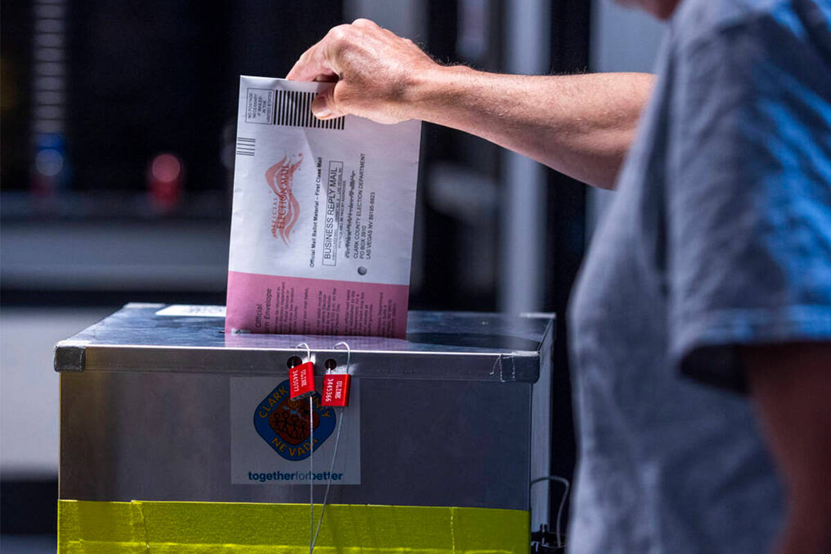 A voter drops off his mail ballot during Nevada's primary election day at the polls within the ...