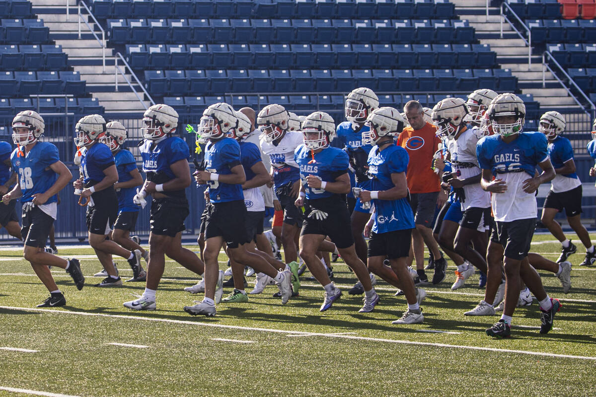 Bishop Gorman football players head off the field at the end of practice on Thursday, Aug. 8, 2 ...