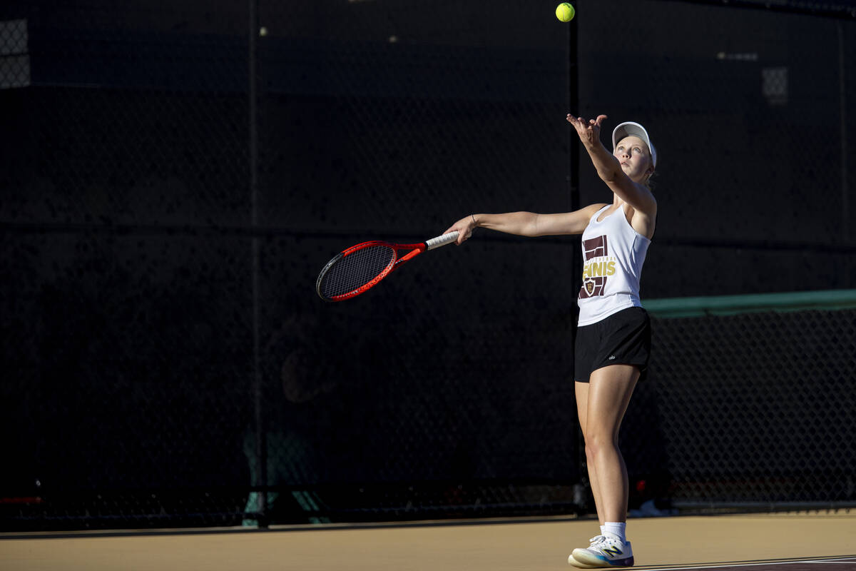 Faith Lutheran sophomore McCauley Hill serves the ball during the tennis matches against The Me ...