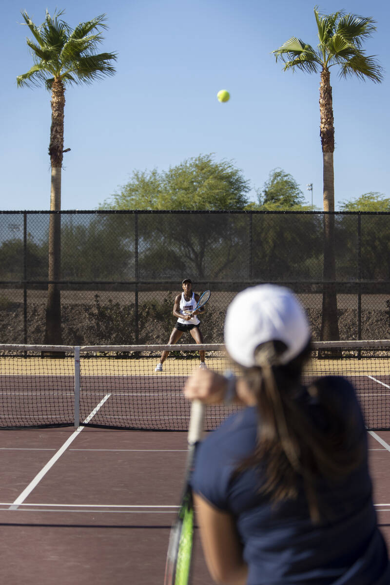 Faith Lutheran senior Zoe Slusher, left, and The Meadows senior Miranda Paek, right, compete du ...