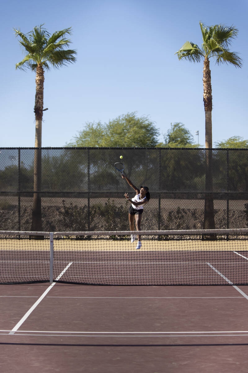 Faith Lutheran senior Zoe Slusher serves the ball during the tennis matches against The Meadows ...