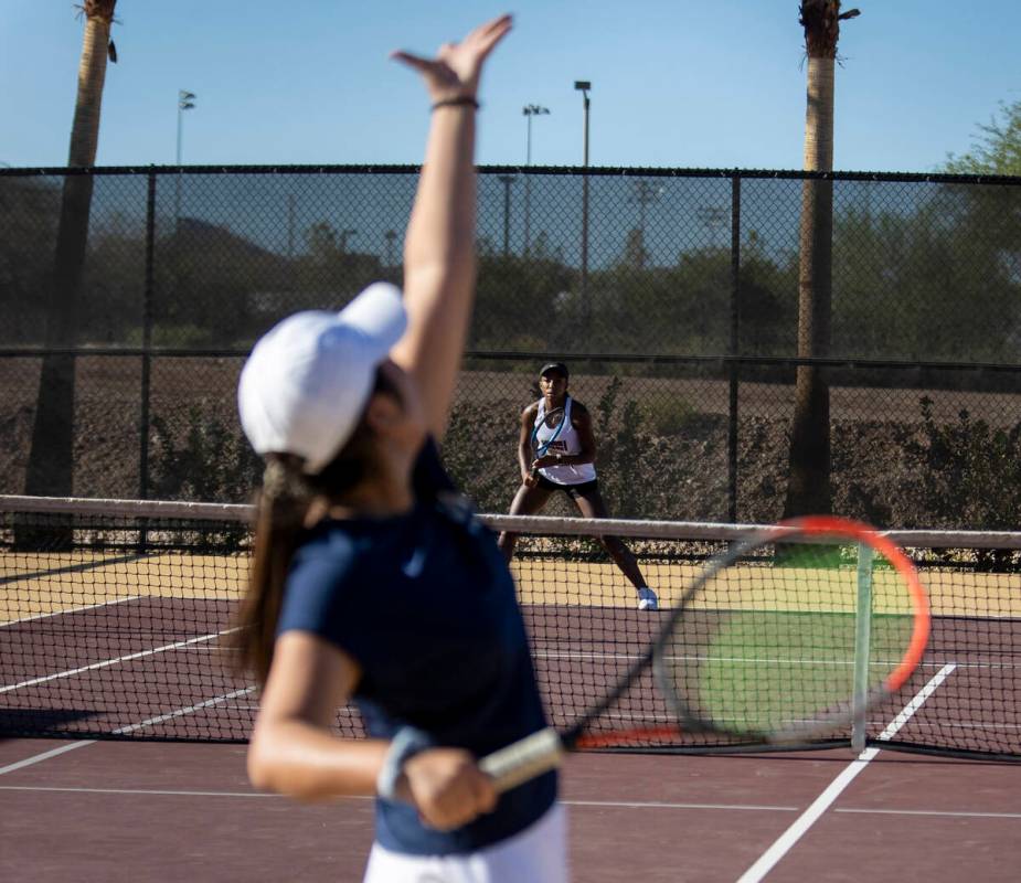 Faith Lutheran senior Zoe Slusher prepares to receive a serve from The Meadows senior Miranda P ...