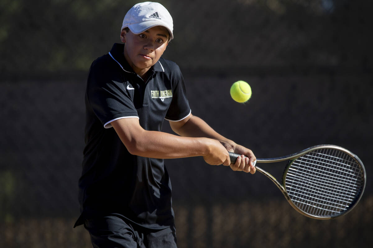 Faith Lutheran freshman Tyson Young competes during the tennis matches against The Meadows at F ...