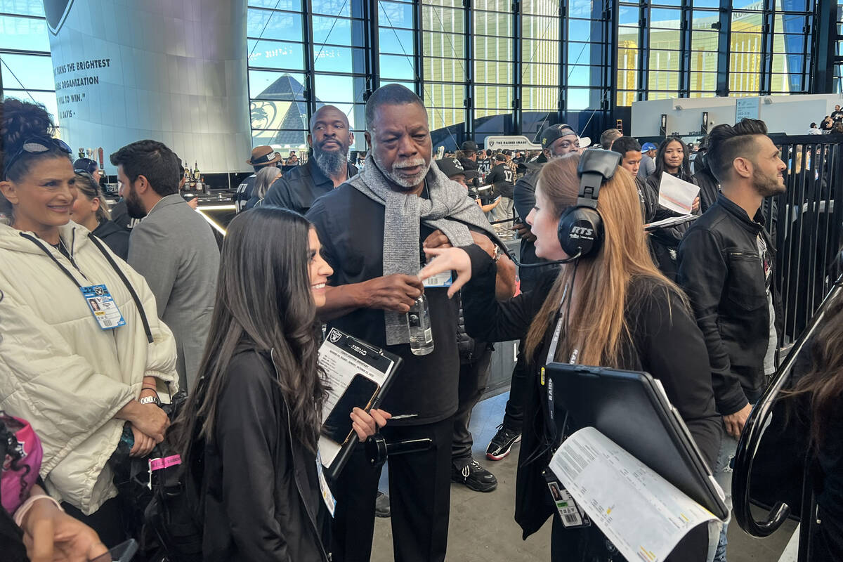 Actor Carl Weathers receives instruction prior to lighting the Al Davis Memorial Torch before a ...