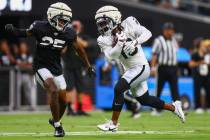 Raiders cornerback Decamerion Richardson (25) pressures wide receiver DJ Turner (19) while he c ...