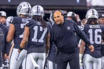 Raiders interim Head Coach Antonio Pierce chats with wide receiver Davante Adams (17) against t ...