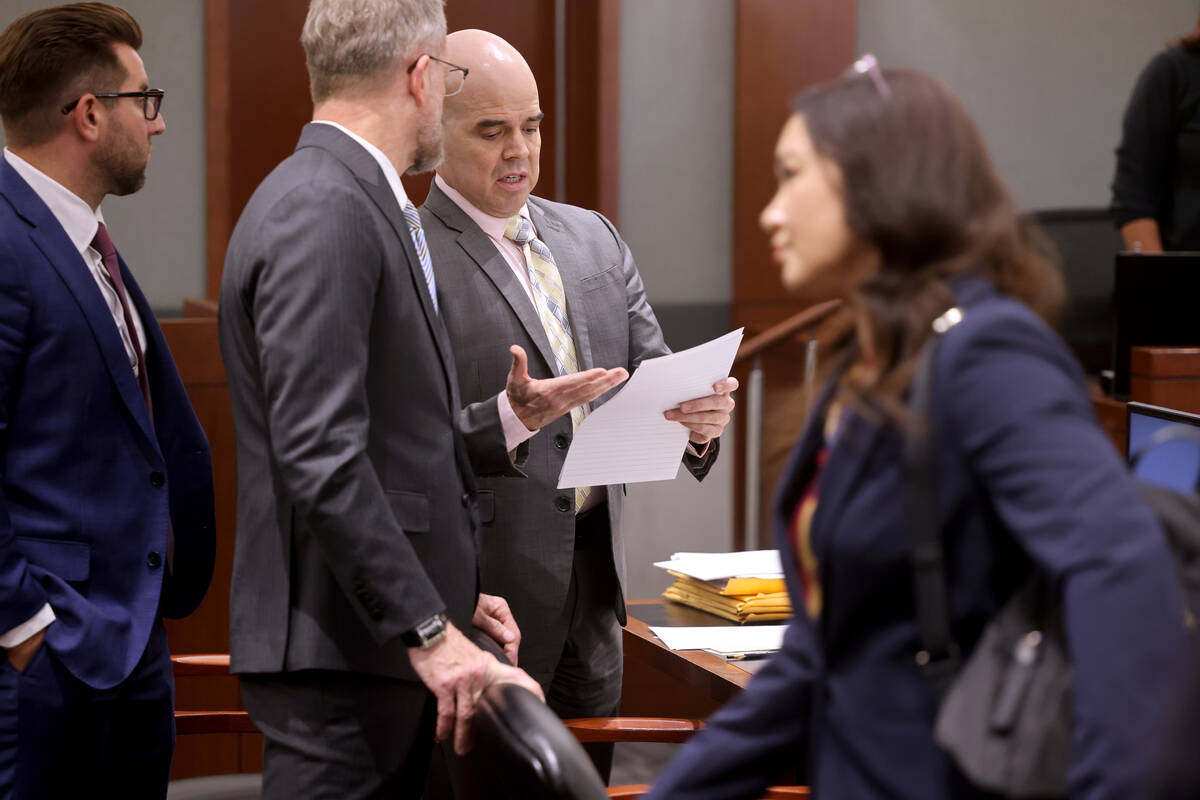 Robert Telles talks with one of his attorneys, Robert Draskovich, as his former employee Robert ...