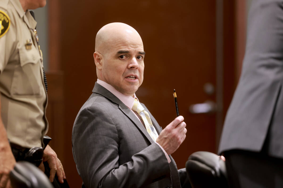 Robert Telles talks to an officer in court during a break in testimony on the fifth day of his ...