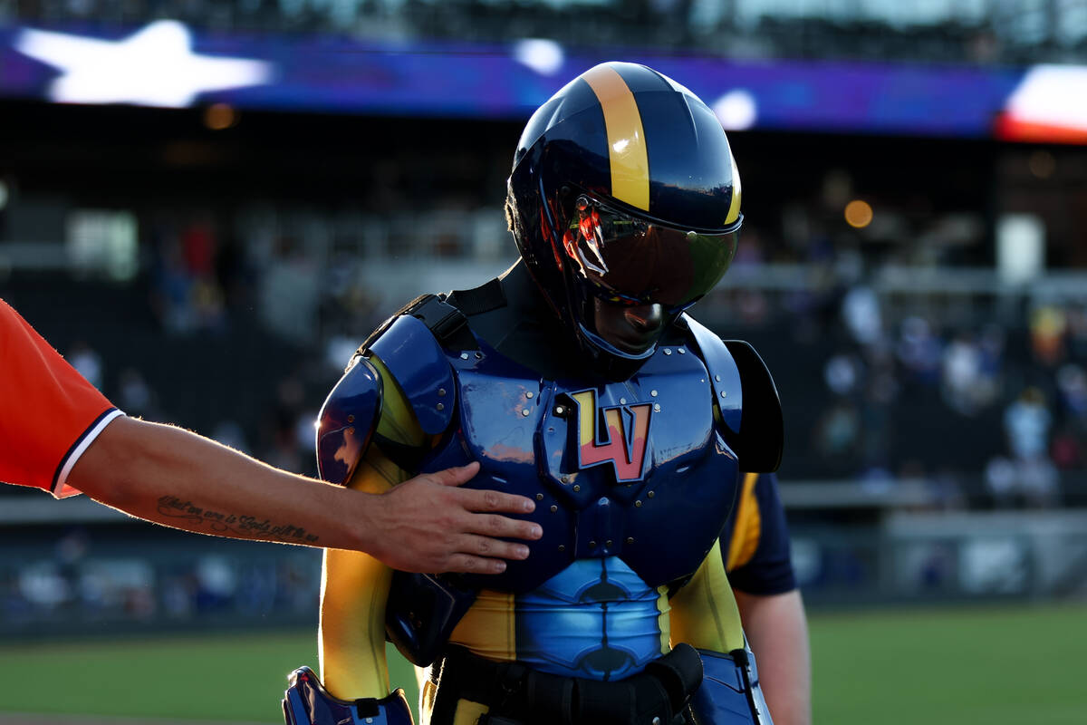 A Las Vegas Aviator pats his mascot during a Minor League Baseball game against the Oklahoma Ci ...