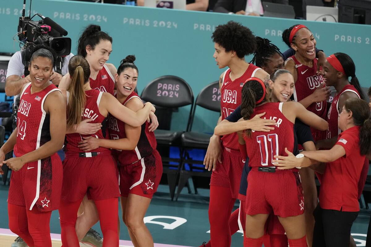 The United States team celebrates after a women's gold medal basketball game at Bercy Arena at ...