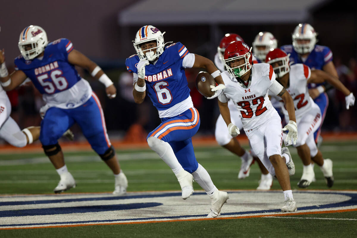 Bishop Gorman wide receiver Brandon Gaea (6) breaks away with the ball while Kahuku defensive b ...