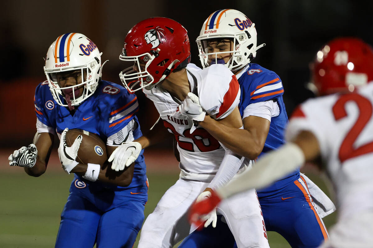 Bishop Gorman wide receiver Greg Toler (8) advances with the ball while wide receiver Kaina Wat ...