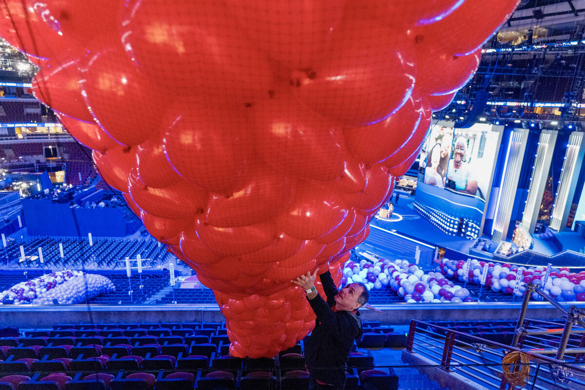 Tony Popelka guides a bag of balloons as preparations are made before the upcoming Democratic N ...