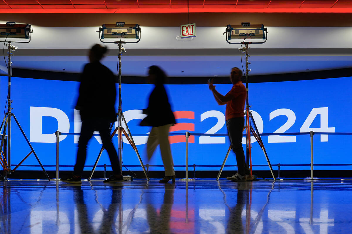 People walk past a display inside the United Center as preparations are made for next week's 20 ...