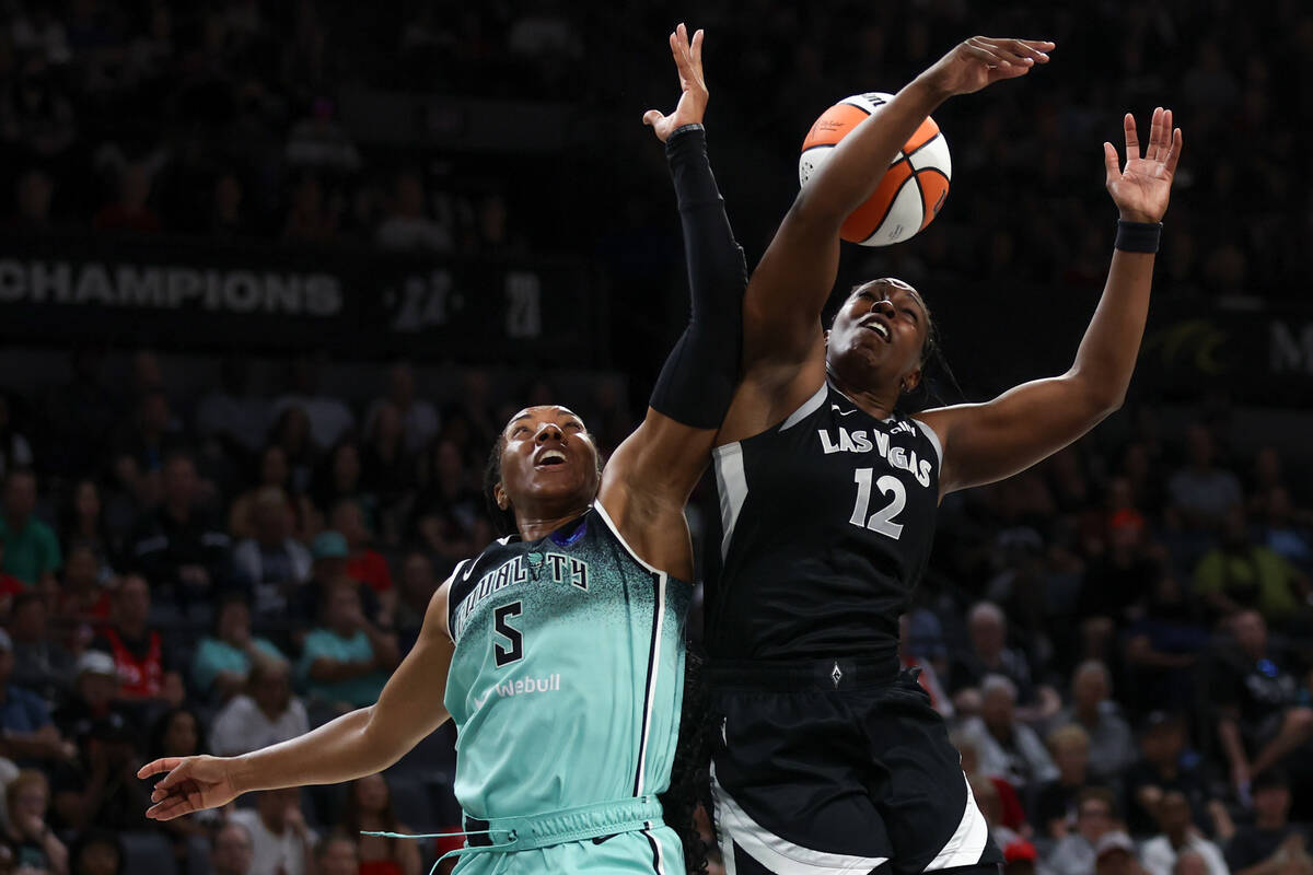 New York Liberty forward Kayla Thornton (5) and Las Vegas Aces guard Chelsea Gray (12) jump for ...