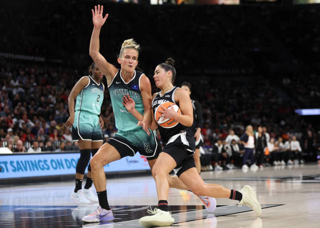 Las Vegas Aces guard Kelsey Plum (10) drives toward the hoop against New York Liberty forward L ...