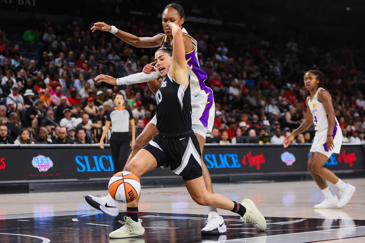 Aces guard Kelsey Plum (10) loses hold of the ball as Los Angeles Sparks forward Azura Stevens ...