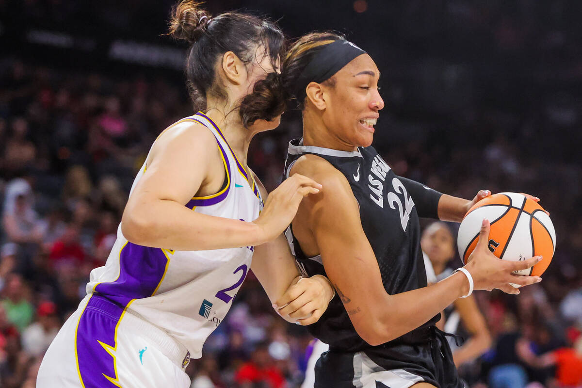 Aces center A'ja Wilson (22) fights to keep the ball in her possession while Los Angeles Sparks ...