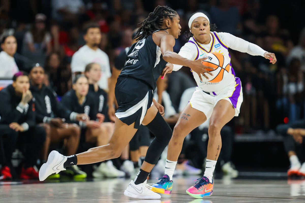 Aces guard Tiffany Hayes (15) dribbles the ball as LA Sparks guard Odyssey Sims (6) guards her ...