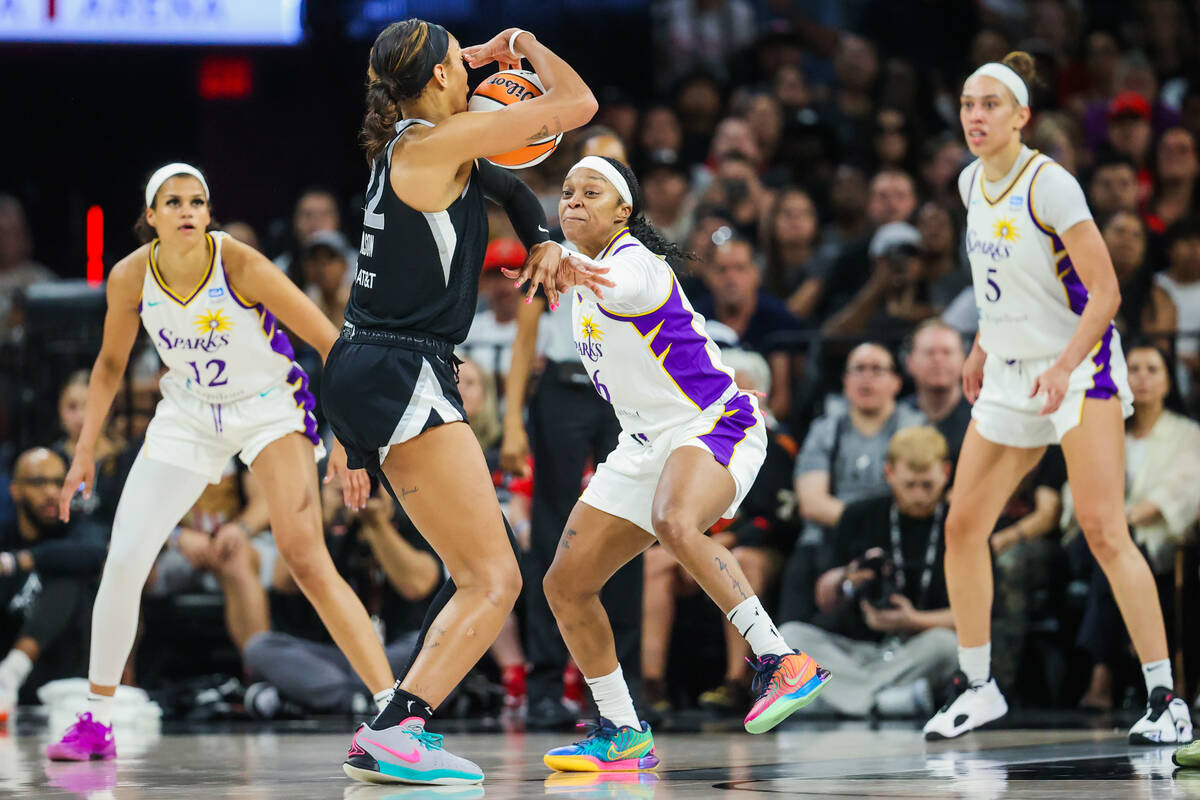 LA Sparks guard Odyssey Sims (6) guards Aces center A'ja Wilson (22) during a WNBA basketball g ...