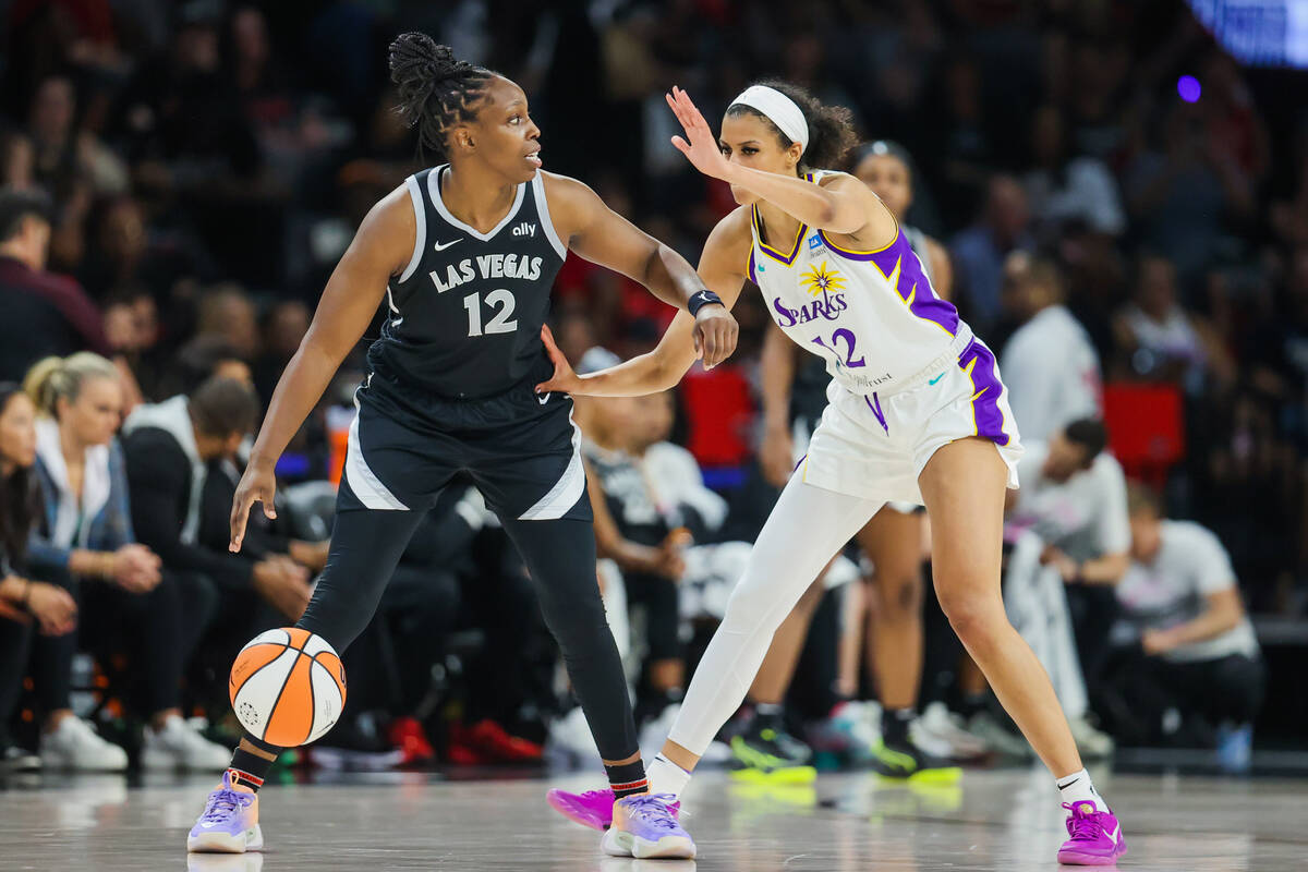 Aces guard Chelsea Gray (12) dribbles the ball as Los Angeles Sparks guard Rae Burrell (12) gua ...