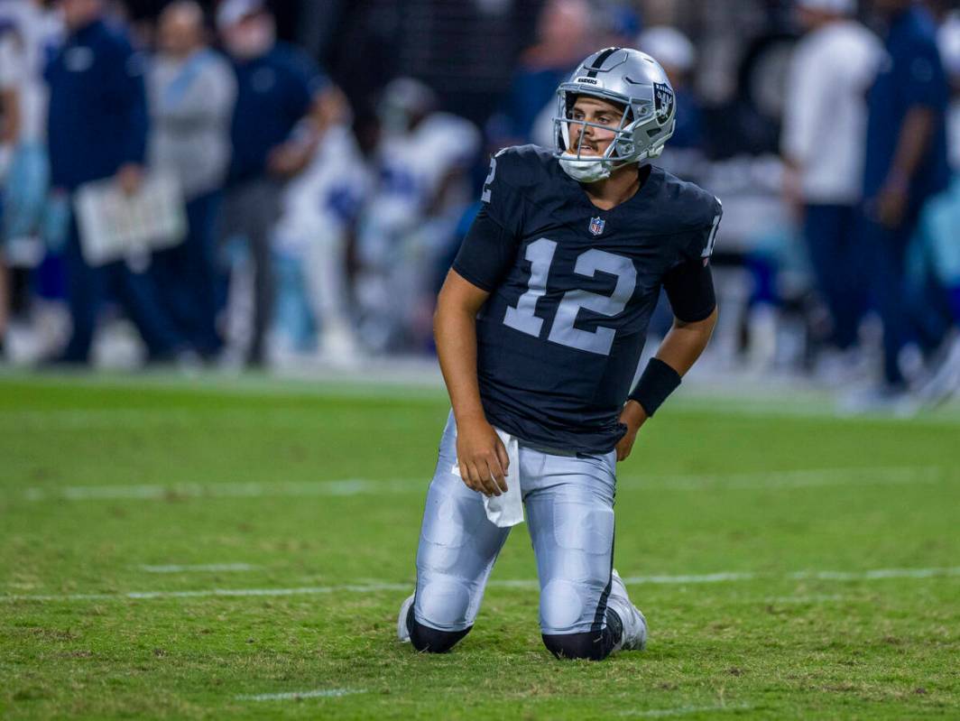 Raiders quarterback Aidan O'Connell (12) looks up from the turf after taken down by Dallas Cowb ...