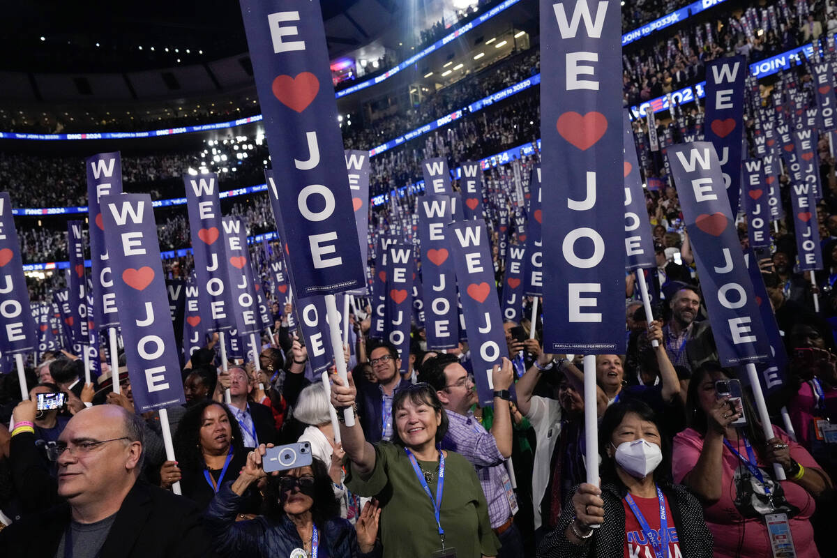 Delegates cheer as President Joe Biden speaks during the first day of Democratic National Conve ...