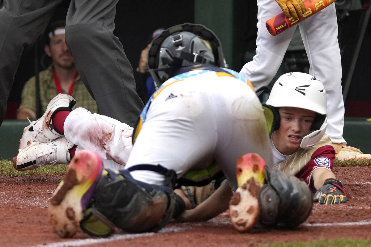 Henderson, Nev.'s Dominic Laino, right, reaches back for home plate as he is tagged out by Wail ...