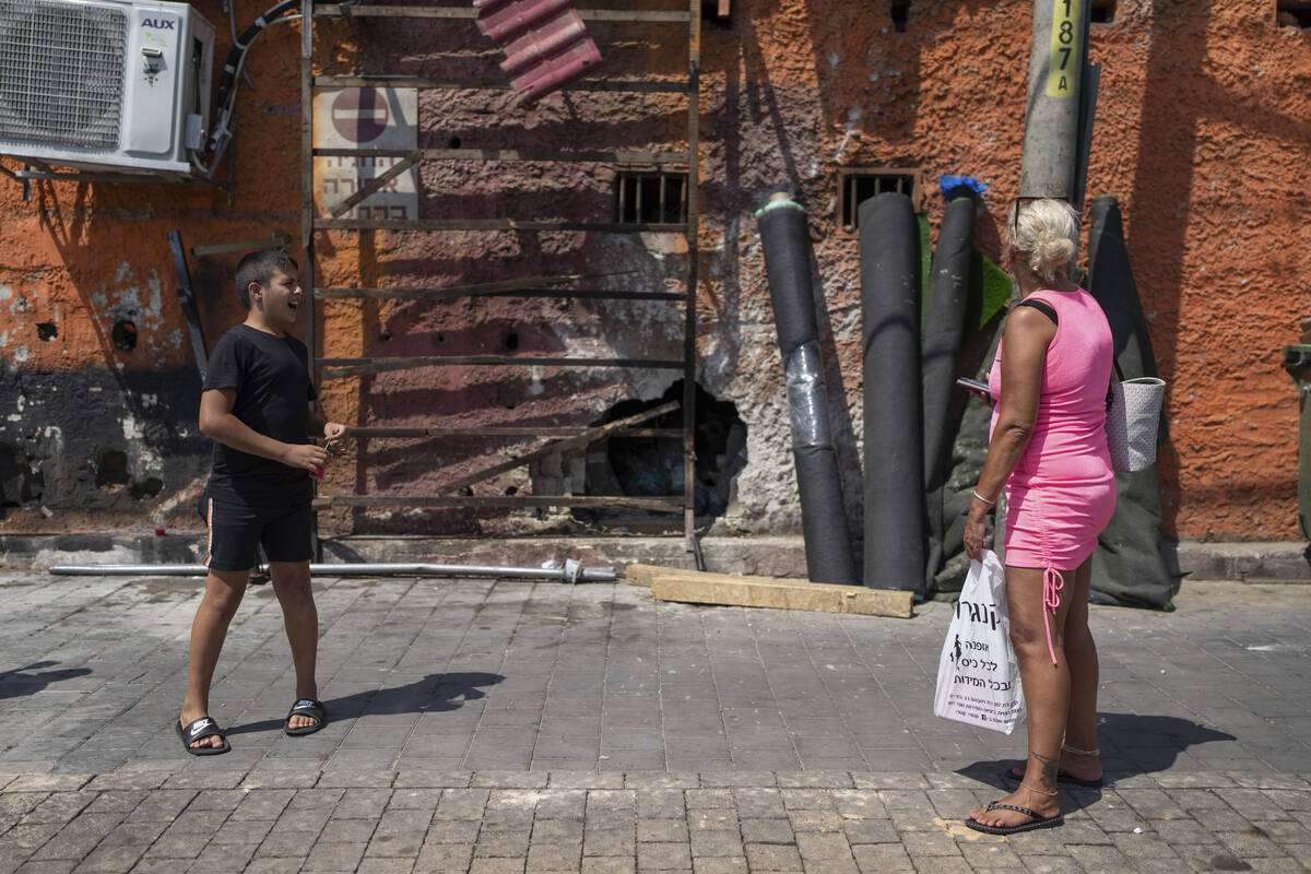 People look at the damage after a bomb explosion in Tel Aviv, Israel, Monday, Aug. 19, 2024. (A ...