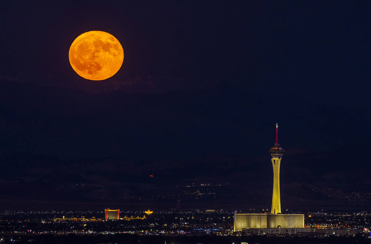 Monday’s blue moon is the third of the four full moons this summer. Is is seen over The Strat ...