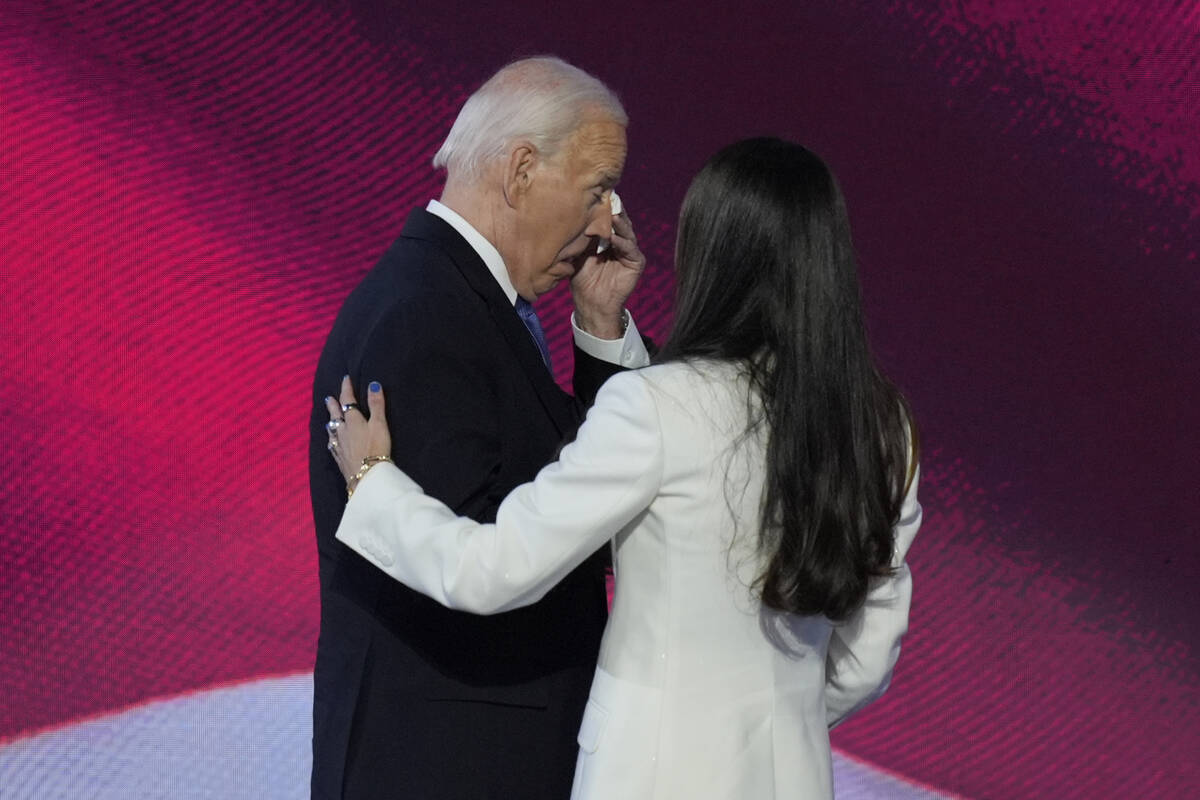 President Joe Biden, left, wipes his eyes after embracing his daughter Ashley Biden, right, on ...