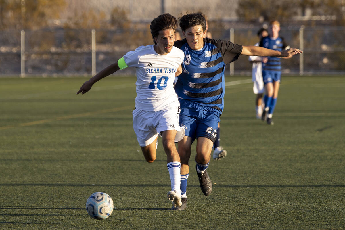 Sierra Vista senior Lazzar Ramos (10) and Basic junior Jeff Sesock (23) compete for the ball du ...