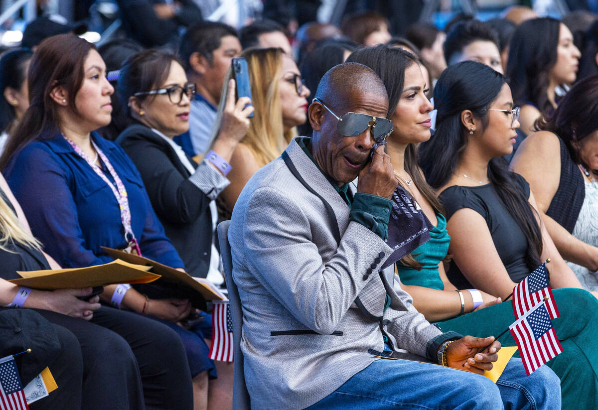 New citizen Lorenzo Jimenez wipes a tear as "America the Beautiful" is played during ...