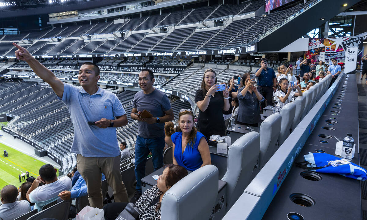 Family members look on as candidates participate in a naturalization ceremony at Allegiant Stad ...