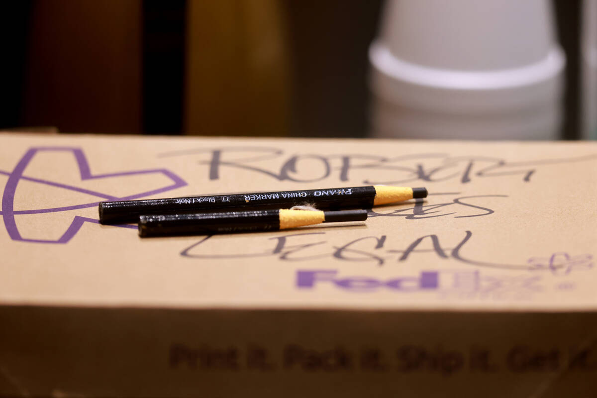 Grease pencils used by Robert Telles are seen at the defense table in court on the seventh day ...