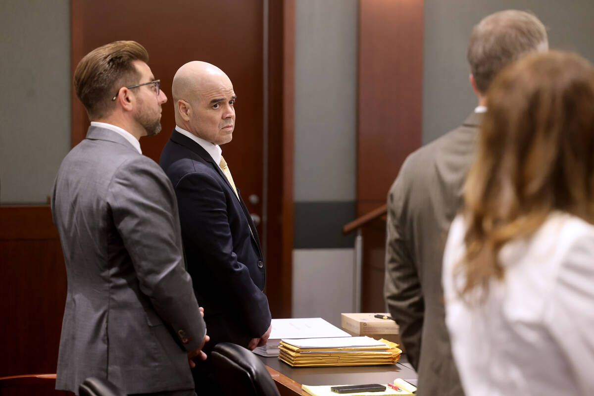 Robert Telles, second from left, listens with one of his attorneys Michael Horvath, left, in co ...