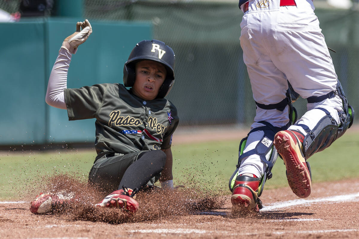 Nevada's Russell McGee (2) slides safely home for their first run against Utah during the ...