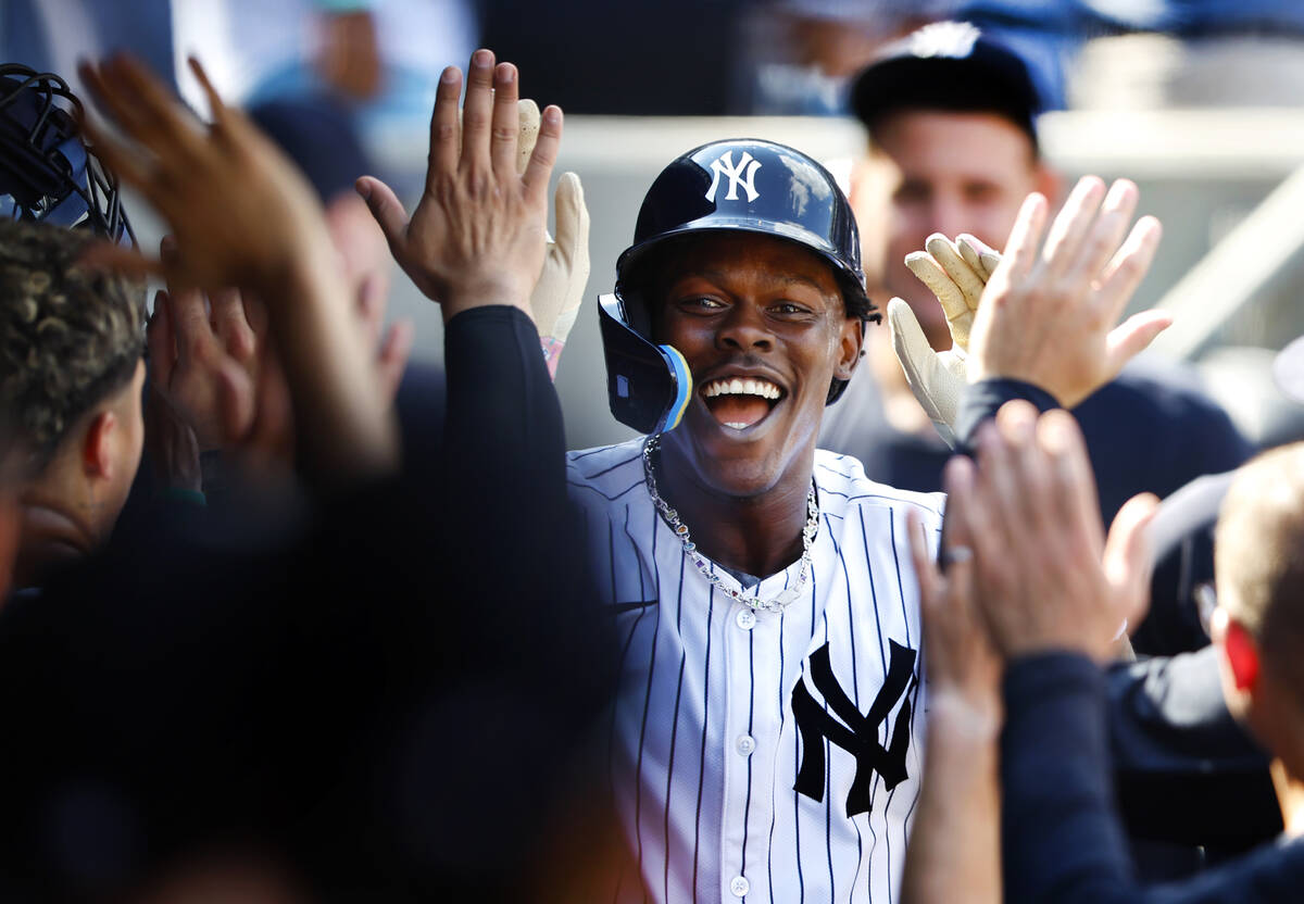 New York Yankees' Jazz Chisholm Jr. (13) celebrates in the dugout with teammates after hitting ...