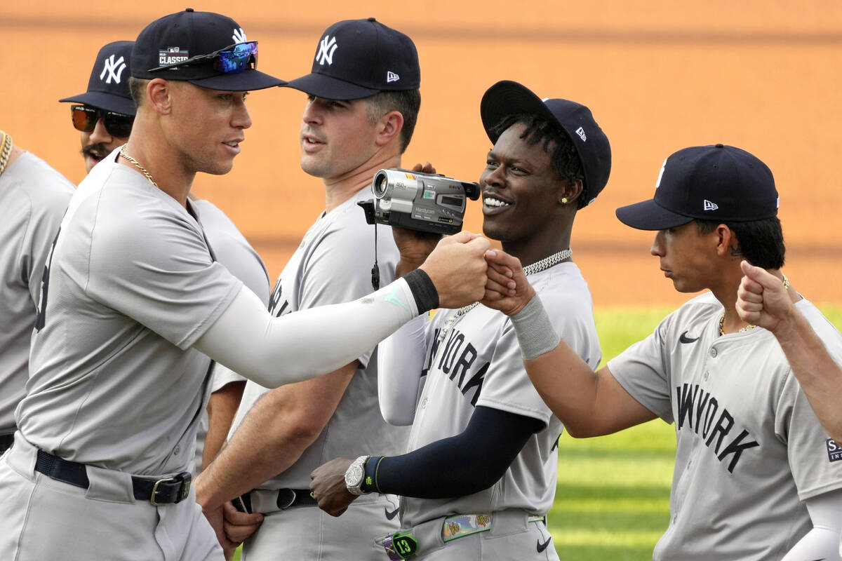 New York Yankees' Aaron Judge, left, is videotaped by Jazz Chisholm, center, as he his introduc ...