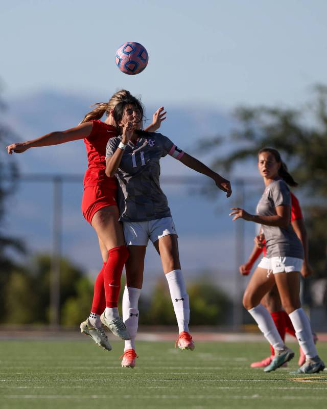 Coronado’s Ella Schultz, left, and Arbor View’s Yalina Shah (11) jump for a heade ...