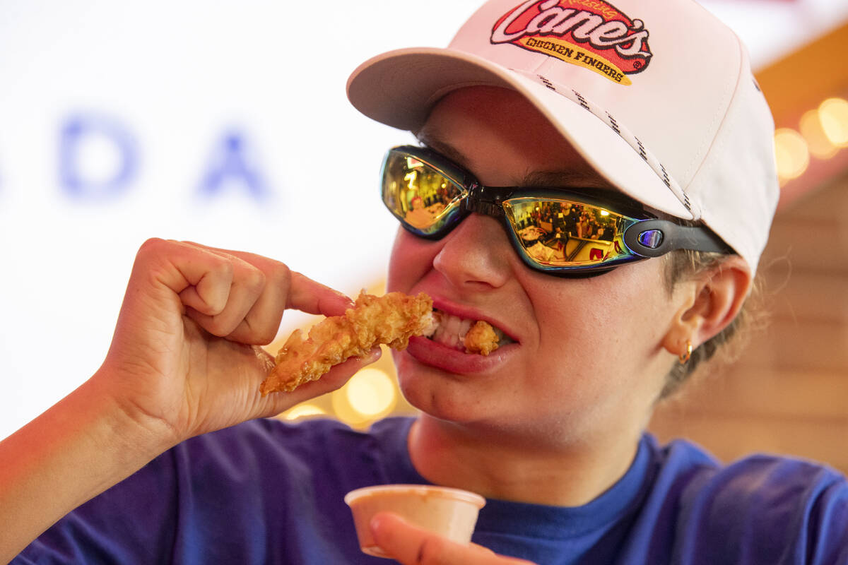 Olympic medalist Katie Grimes eats a chicken finger during a promotional homecoming “shi ...