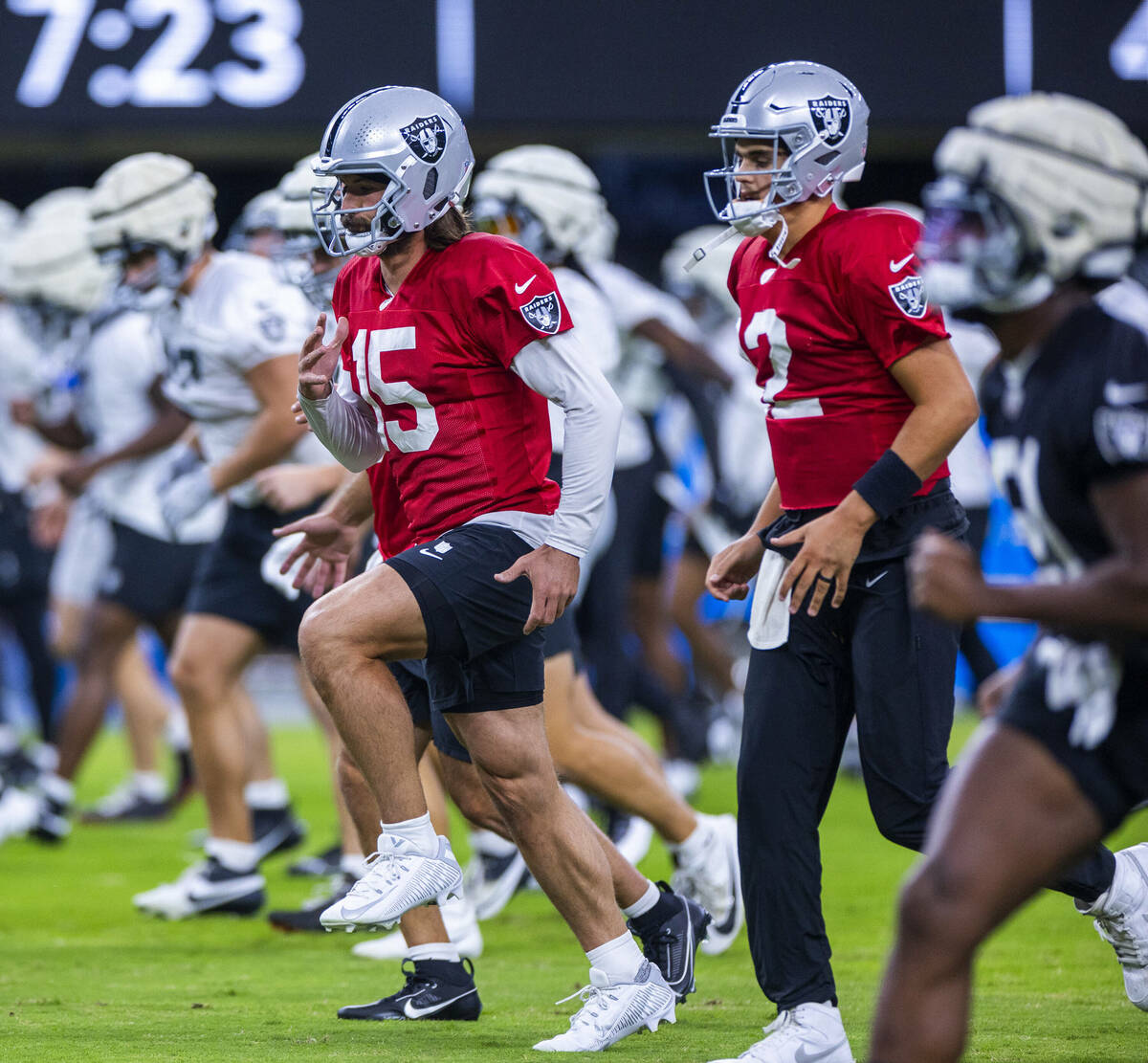 Raiders quarterback Gardner Minshew (15) and quarterback Aidan O'Connell (12) join teammates in ...